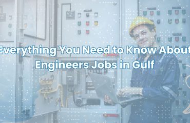 Engineer working on electrical control panel with laptop – Engineers Jobs in Gulf